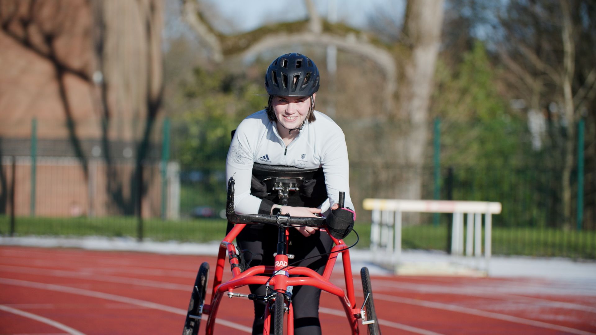 Photo of Tully Kearney in her running frame on an athletics track