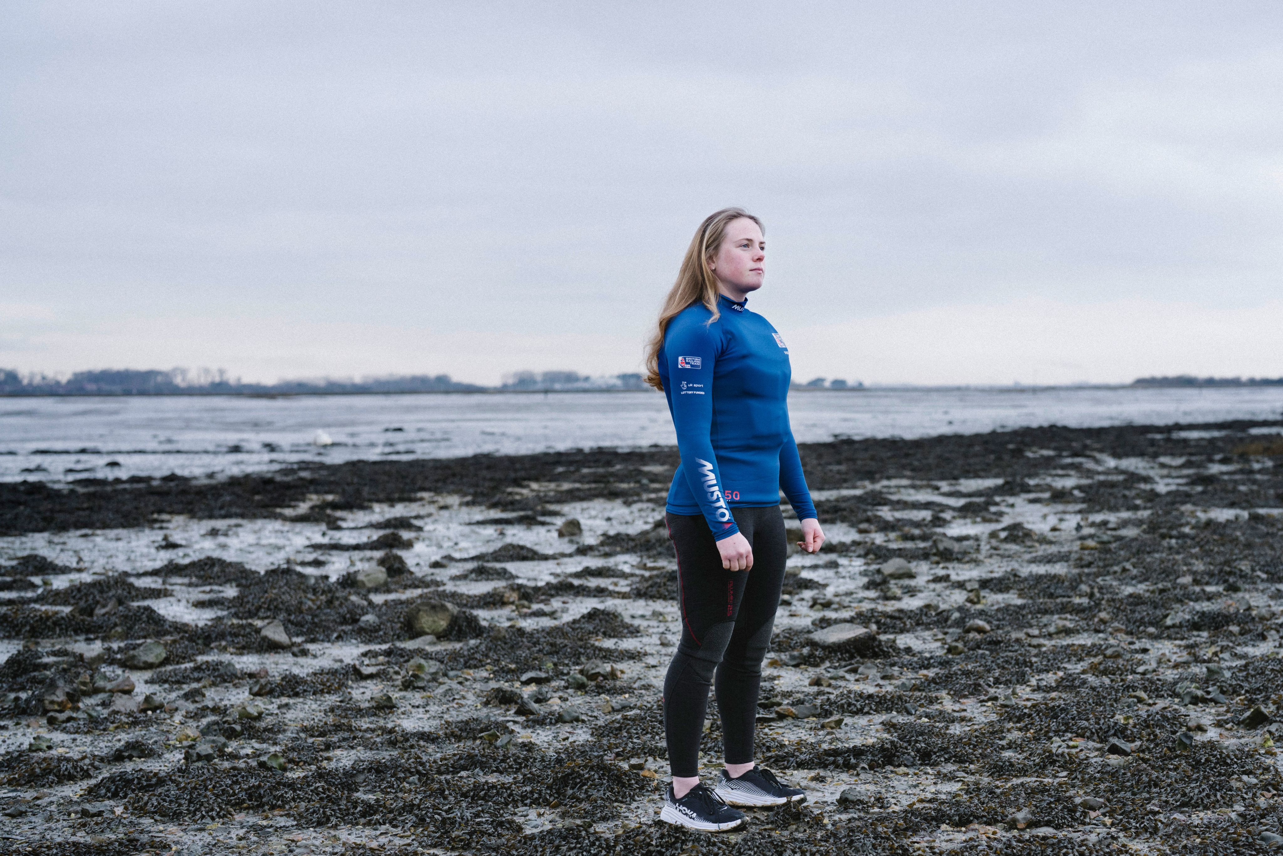 Young female sailor stands on shore