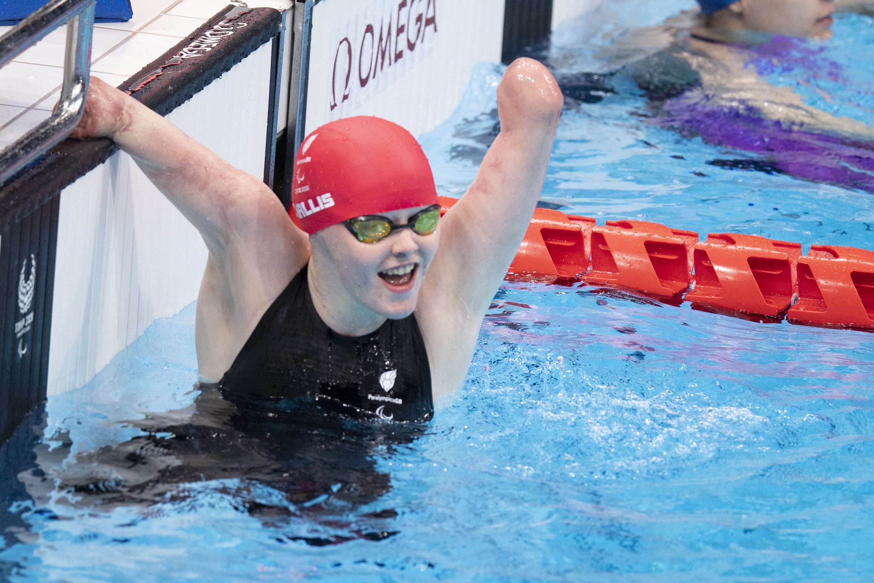 ParalympicsGB athlete celebrating in the swimming pool at the end of a race
